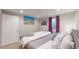 King-size bed, window, and artwork feature in this finished basement bedroom at 2881 W 65Th Ave, Denver, CO 80221