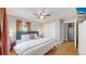 King-size bed in bright bedroom with ceiling fan and hardwood floors at 2881 W 65Th Ave, Denver, CO 80221