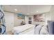 King-size bed, TV and large window in this well-lit basement bedroom at 2881 W 65Th Ave, Denver, CO 80221