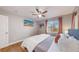 King-size bed in well-lit bedroom with hardwood floors at 2881 W 65Th Ave, Denver, CO 80221