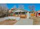 Newly renovated gray house with a small front yard and white picket fence at 2881 W 65Th Ave, Denver, CO 80221