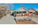 Gray house with wooden porch, white picket fence, and small garden at 2881 W 65Th Ave, Denver, CO 80221