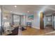Cozy living room with hardwood floors, brown couch, and large TV at 2881 W 65Th Ave, Denver, CO 80221