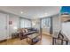 Living room featuring hardwood floors, a brown couch, and ample natural light at 2881 W 65Th Ave, Denver, CO 80221