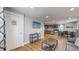 Open concept living area with hardwood floors, a comfortable couch and kitchen with stainless steel appliances at 2881 W 65Th Ave, Denver, CO 80221