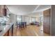 Open concept kitchen and living area with hardwood floors and ample light at 2881 W 65Th Ave, Denver, CO 80221