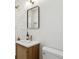 Modern bathroom features a sleek vanity, stylish mirror, and updated fixtures at 4465 N Umatilla St, Denver, CO 80211