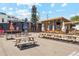 Outdoor seating area with picnic tables and umbrellas in a relaxed setting at 4465 N Umatilla St, Denver, CO 80211