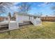 Charming home exterior featuring a spacious deck and well-maintained lawn at 9565 W 12Th Pl, Lakewood, CO 80215