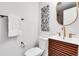 Stylish half-bathroom featuring wood vanity with white counter, gold fixtures and unique decorative art at 9565 W 12Th Pl, Lakewood, CO 80215