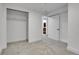 Cozy bedroom with closet, entry to bathroom, and carpet at 9565 W 12Th Pl, Lakewood, CO 80215