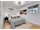 Comfortable bedroom with natural light, neutral color scheme, and stylish decor at 9565 W 12Th Pl, Lakewood, CO 80215