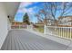 Expansive deck offers outdoor living space with scenic views of the yard at 9565 W 12Th Pl, Lakewood, CO 80215