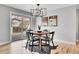 Cozy dining area featuring modern light fixture and sliding glass doors to the backyard at 9565 W 12Th Pl, Lakewood, CO 80215