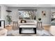 Bright living room with modern décor, large windows, and sleek black and white rug at 9565 W 12Th Pl, Lakewood, CO 80215