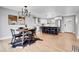 Bright and open living room, dining area and kitchen featuring wood floors and modern design at 9565 W 12Th Pl, Lakewood, CO 80215