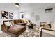 Cozy living area with a comfortable sectional sofa, round table, and neutral armchairs at 9565 W 12Th Pl, Lakewood, CO 80215