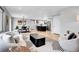Open concept living room, dining area, and kitchen with hardwood floors and modern fixtures at 9565 W 12Th Pl, Lakewood, CO 80215
