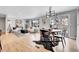 Open-concept living room boasts modern furnishings, hardwood floors, large windows and access to the dining area at 9565 W 12Th Pl, Lakewood, CO 80215