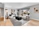Bright living room with modern decor, large windows, and sleek black and white rug at 9565 W 12Th Pl, Lakewood, CO 80215