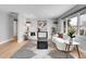Living room featuring hardwood floors, neutral paint, modern furniture, and large windows for natural light at 9565 W 12Th Pl, Lakewood, CO 80215