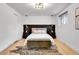 Cozy main bedroom featuring dark wood accents, soft lighting, and hardwood floors at 9565 W 12Th Pl, Lakewood, CO 80215