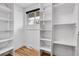 Spacious walk-in closet with custom shelving and natural light, perfect for organizing at 9565 W 12Th Pl, Lakewood, CO 80215