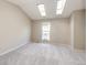 Bedroom featuring vaulted ceilings with skylights, neutral walls, and a bright window at 8231 S Fillmore Way, Centennial, CO 80122