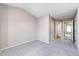 Carpeted bedroom featuring neutral walls, closet space, and access to a bathroom with vanity and shower at 8231 S Fillmore Way, Centennial, CO 80122