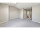 A spacious bedroom with neutral walls, carpet, access to closet space and adjoining bathroom at 8231 S Fillmore Way, Centennial, CO 80122