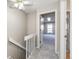 Upstairs hallway featuring neutral walls and carpet with an open bedroom door and adjacent closet door at 8231 S Fillmore Way, Centennial, CO 80122