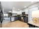 Bright kitchen boasts stainless steel appliances, granite counters, and tile floor at 8231 S Fillmore Way, Centennial, CO 80122