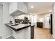 Kitchen featuring updated appliances, countertop bar, and tile flooring at 8231 S Fillmore Way, Centennial, CO 80122