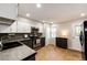 Well-lit kitchen features updated appliances, countertops, and tile floors at 8231 S Fillmore Way, Centennial, CO 80122