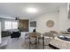 Open-concept living and dining area with a brick accent wall and modern decor at 8231 S Fillmore Way, Centennial, CO 80122