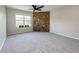 Bright living room featuring a stone accent wall and window for natural light at 8231 S Fillmore Way, Centennial, CO 80122