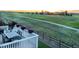 Inviting back deck with seating and a beautiful view of the golf course and evening sky at 16701 Buffalo Run Dr, Commerce City, CO 80022