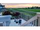 Relaxing back patio with comfortable seating and a fire pit overlooking a golf course at sunset at 16701 Buffalo Run Dr, Commerce City, CO 80022