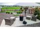 Charming backyard with a fire pit, putting green, and comfortable seating area at 16701 Buffalo Run Dr, Commerce City, CO 80022