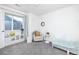 Brightly lit ' bedroom with a comfortable reading nook and bookshelves near the window at 16701 Buffalo Run Dr, Commerce City, CO 80022