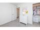 Well-organized bedroom with a dresser and walk-in closet filled with dresses and storage boxes at 16701 Buffalo Run Dr, Commerce City, CO 80022