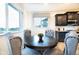 Cozy dining nook featuring a round table, upholstered chairs, and ample natural light at 16701 Buffalo Run Dr, Commerce City, CO 80022