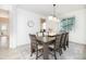 Bright dining room featuring a wooden table, seating for eight, and view to the outdoors at 16701 Buffalo Run Dr, Commerce City, CO 80022
