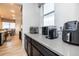 Kitchen area featuring modern appliances on the countertop with view to the dining area at 16701 Buffalo Run Dr, Commerce City, CO 80022