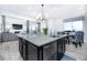 Modern kitchen features a large center island, stainless steel appliances, and ample lighting at 16701 Buffalo Run Dr, Commerce City, CO 80022