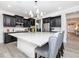 Stylish kitchen with dark cabinetry, stainless steel appliances, and a spacious island at 16701 Buffalo Run Dr, Commerce City, CO 80022