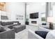 Living room with a modern fireplace, plush seating, and a staircase leading to the upper level at 16701 Buffalo Run Dr, Commerce City, CO 80022
