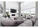 Spacious living room featuring high ceilings, modern fireplace, and oversized comfortable seating at 16701 Buffalo Run Dr, Commerce City, CO 80022