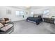 Spacious main bedroom with carpeted floors, two windows and comfortable seating area at 16701 Buffalo Run Dr, Commerce City, CO 80022