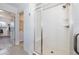 A pristine all-white tile and glass shower in the bathroom at 16701 Buffalo Run Dr, Commerce City, CO 80022